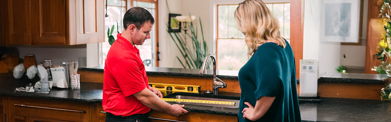 Service professional at a sink with a customer.