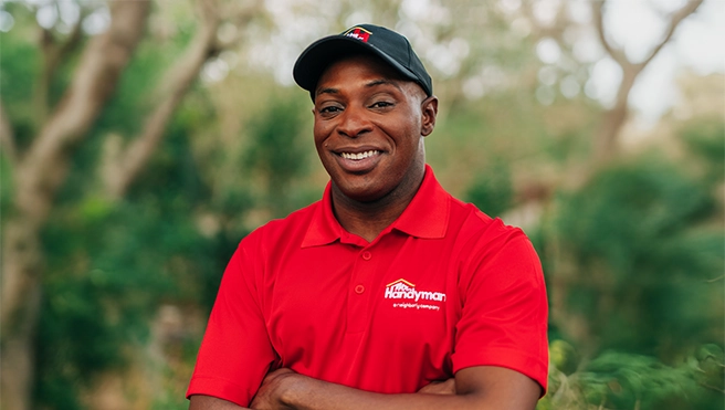 Mr. Handyman professional standing outside smiling.