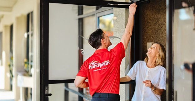 MRH employee fixing a businesses door.