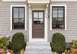 Two windows surrounding entry door.