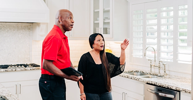Employee discussing remodeling plans with a client.