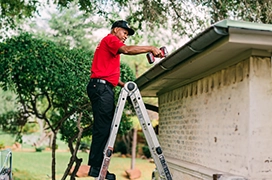 MRH employee on a ladder for roof repair.