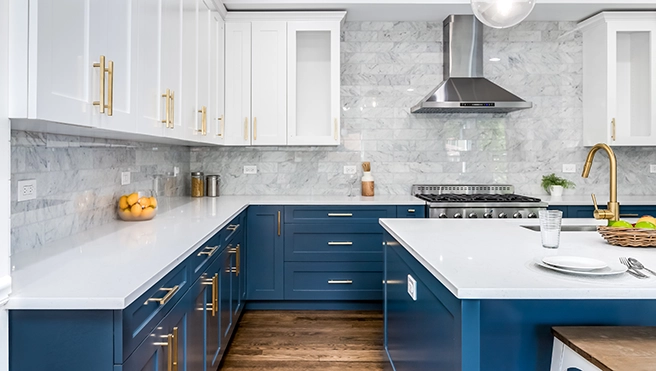 Modern kitchen with white cupboards, and a table.