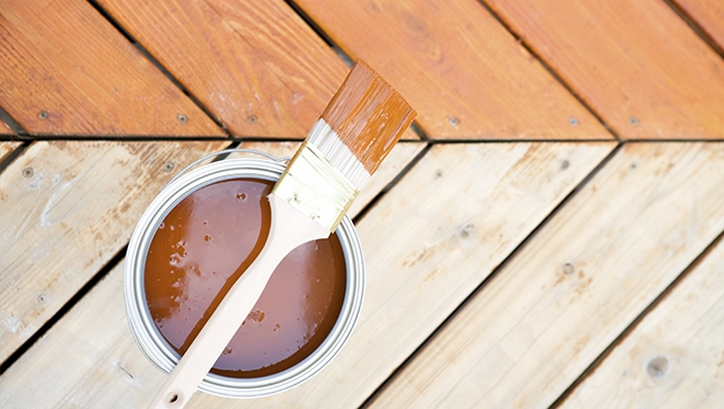 Paint brush on wooden floor.