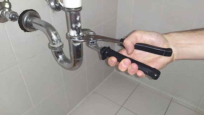 MRH employee inspecting and adjusting pipes.