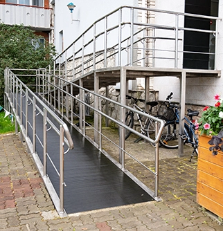 A wheelchair ramp made of metal leads.