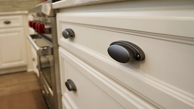 Modern kitchen drawer with sleek dark handles.