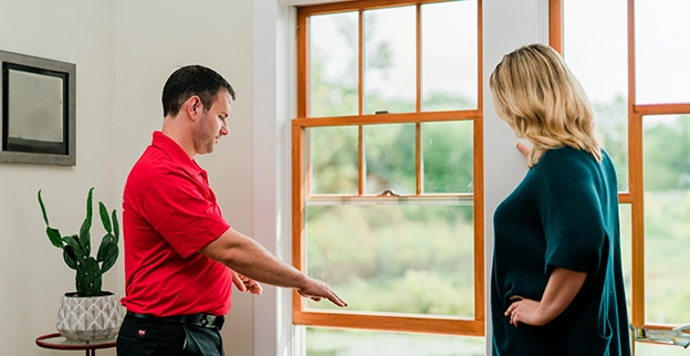 Mr. Handyman talking to a client.