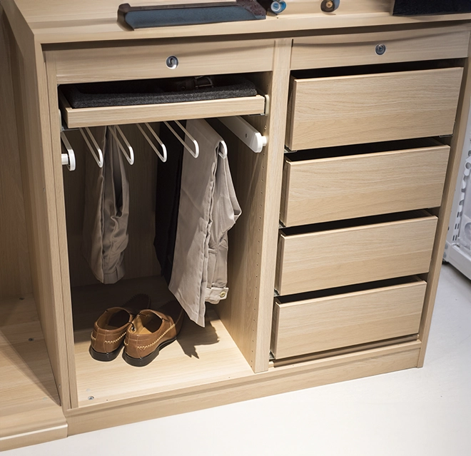 A wood cabinet featuring hanging clothes.