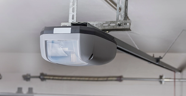 A modern garage door opener mounted on a ceiling.