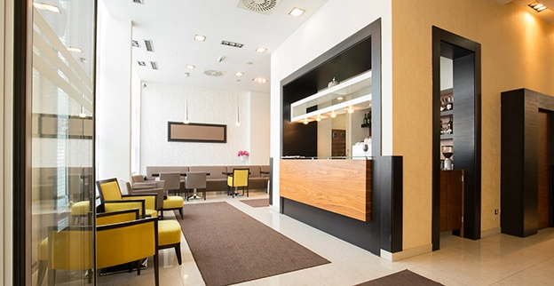 Bright and modern hotel lobby featuring a reception desk.