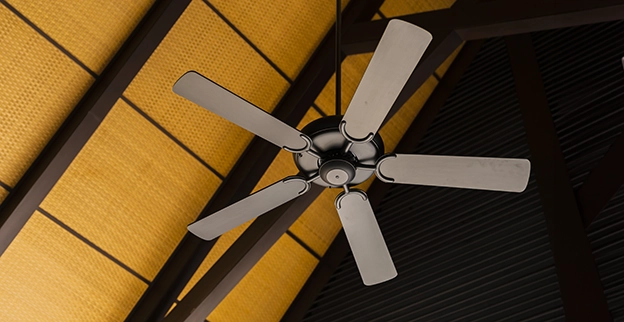 A modern ceiling fan with five blades hangs from a wooden-beamed ceiling.