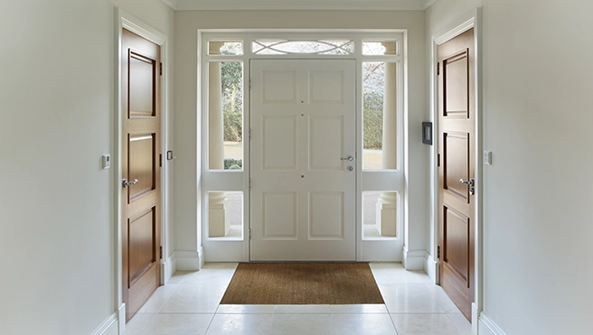 Bright and spacious entryway featuring a central white door.