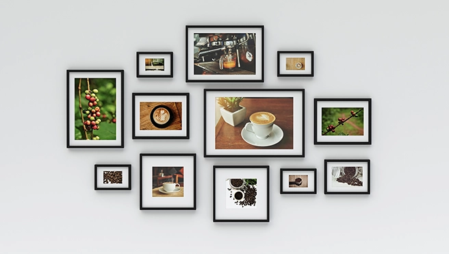 A collection of framed photos showcasing on a light gray wall.
