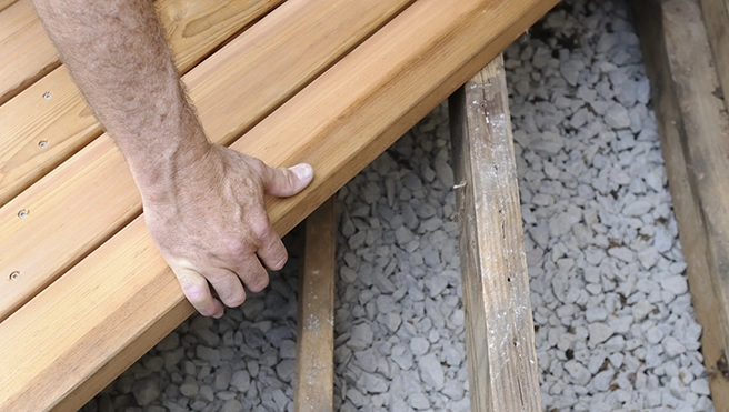 Person securing a wooden frame.