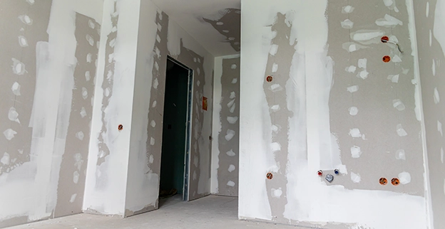 Interior of a partially finished room with drywall.