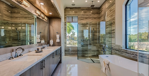 Elegant bathroom featuring a modern shower, a freestanding bathtub, dual sinks.