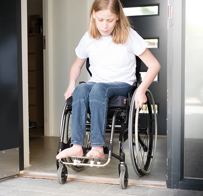 Girl sitting in a wheelchair.