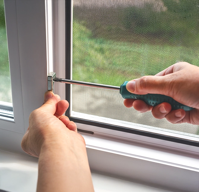 Technician fixing a window.