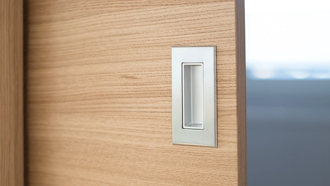 Close-up of lock on wooden door.