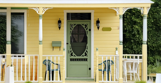 Front view of a yellow painted home.