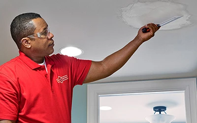 Mr. Handyman professional repairing ceiling drywall