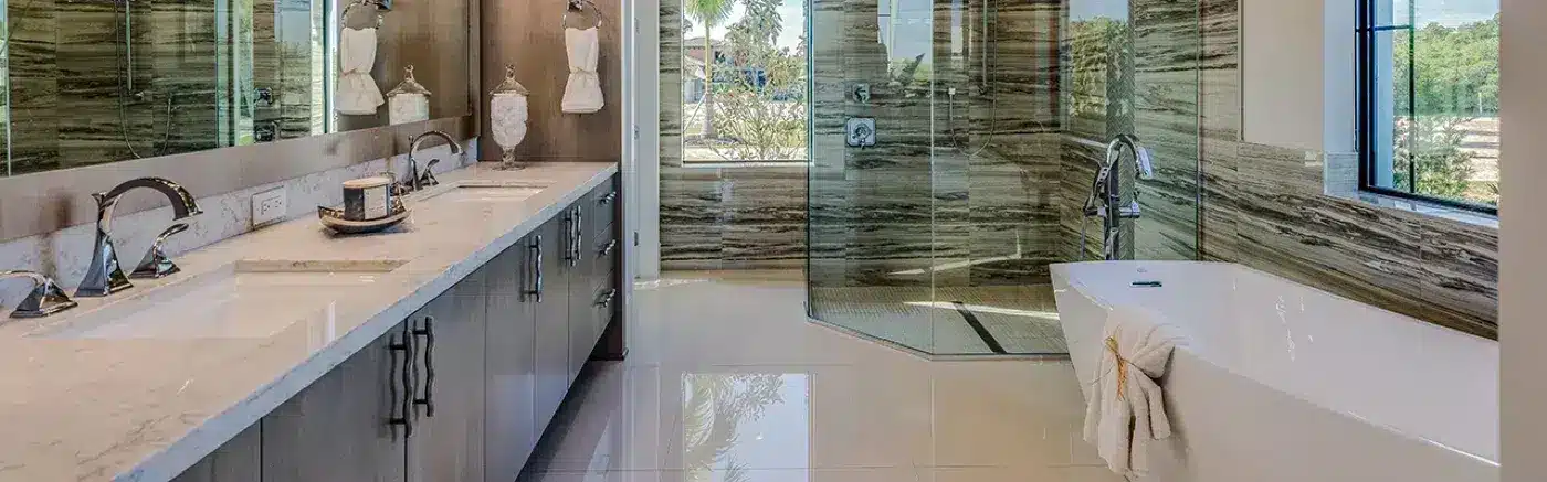 A newly remodeled modern bathroom featuring a double vanity, a freestanding bathtub, and a glass-enclosed shower.