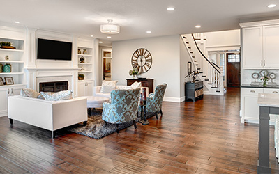 Living room and entryway with wood floor.