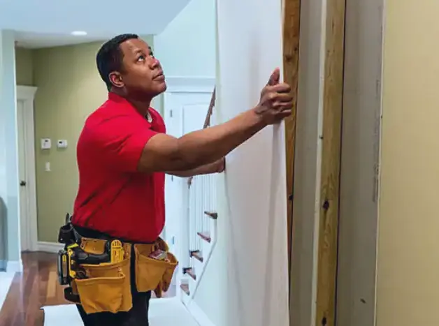 MRH Technician handing drywall in a customer's home.